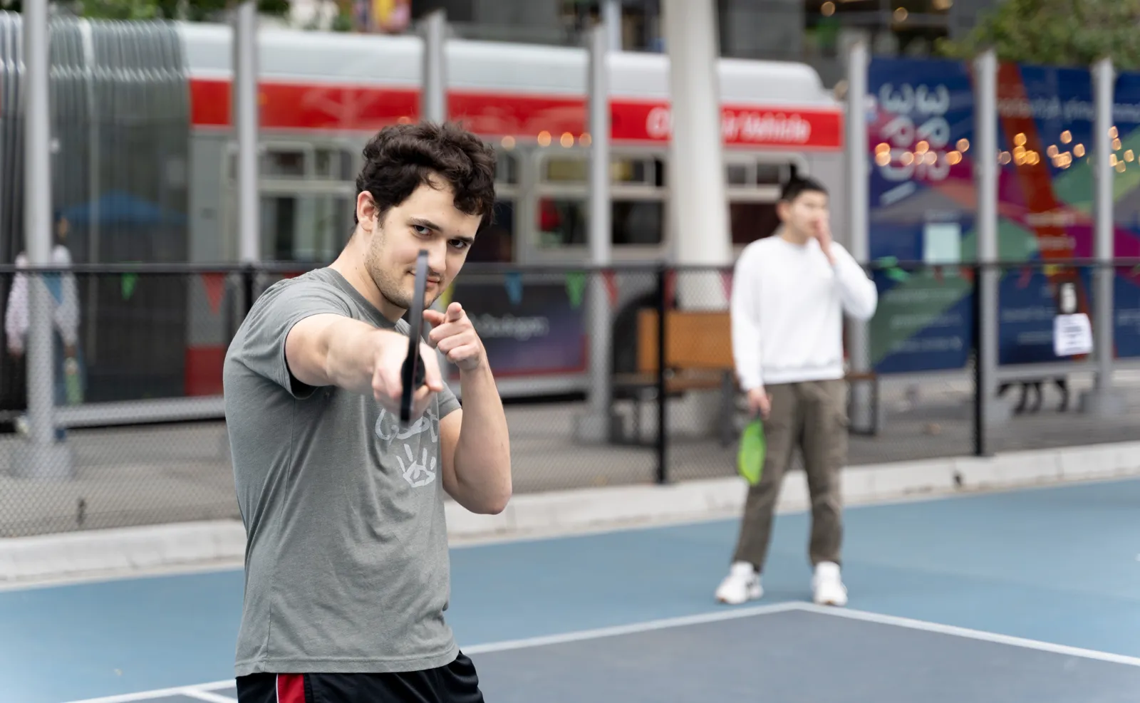 Engineer, Evan Lohn, playing pickleball while striking a pose.