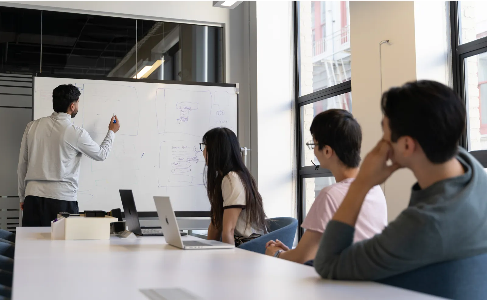 The Onyx team gathered around the whiteboard, discussing new ideas.
