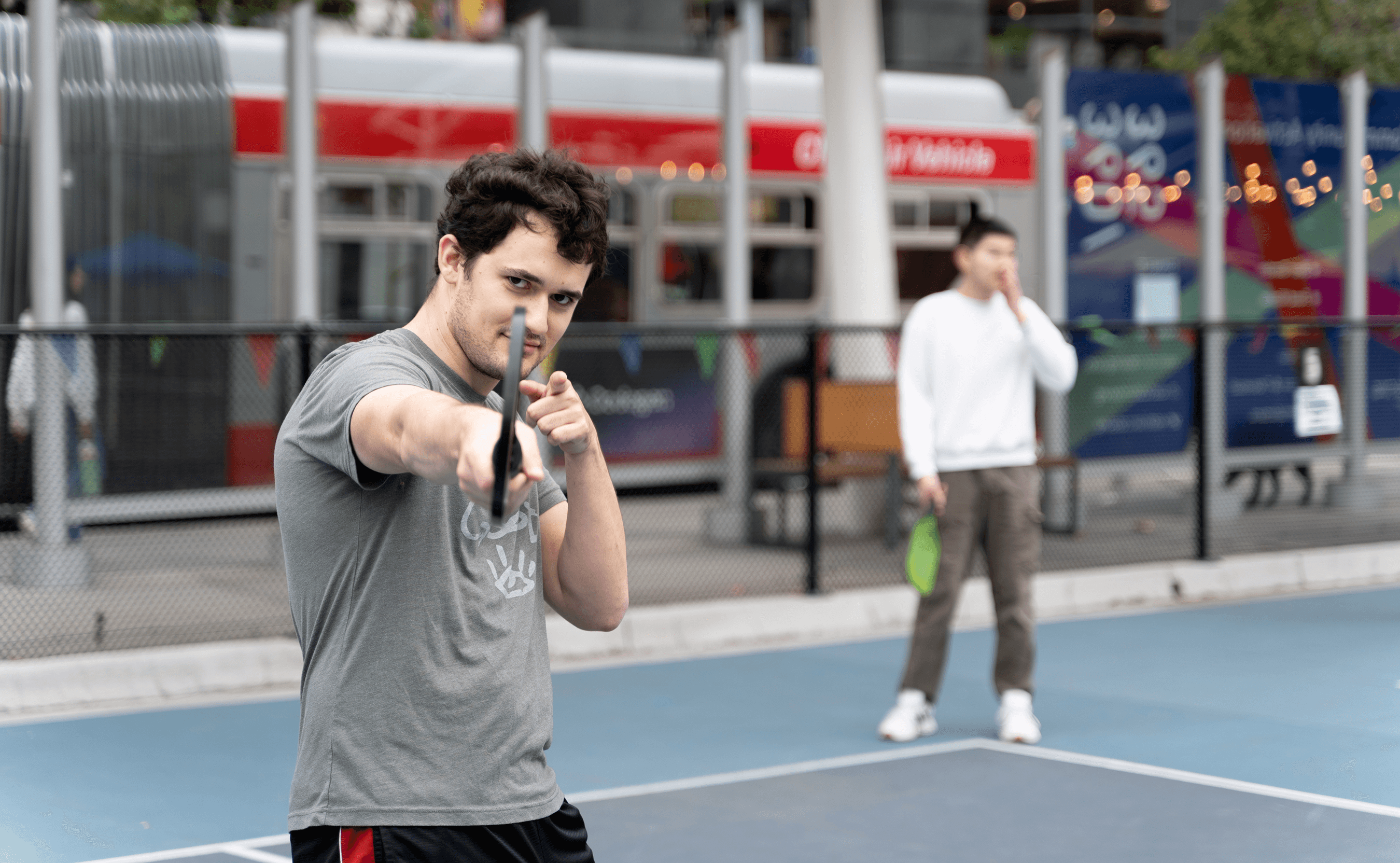 Engineer, Evan Lohn, playing pickleball while striking a pose.