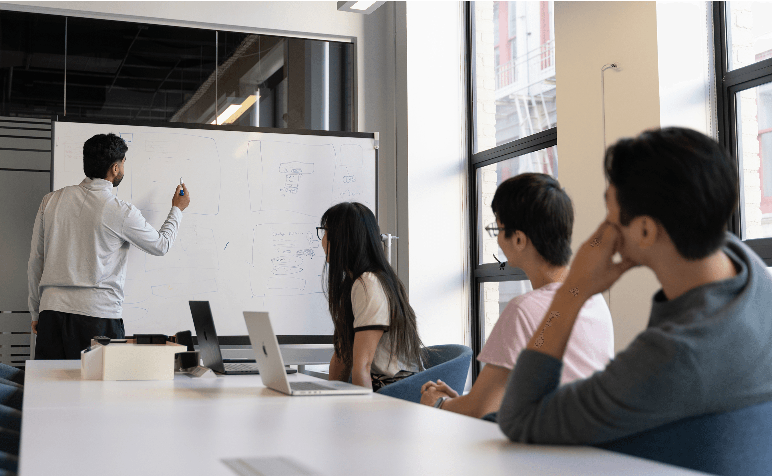 The Onyx team gathered around the whiteboard, discussing new ideas.